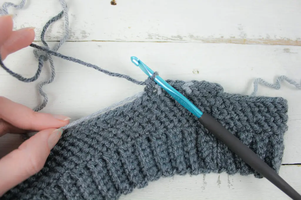 Stop with two loops left on hook and pull through with next color.