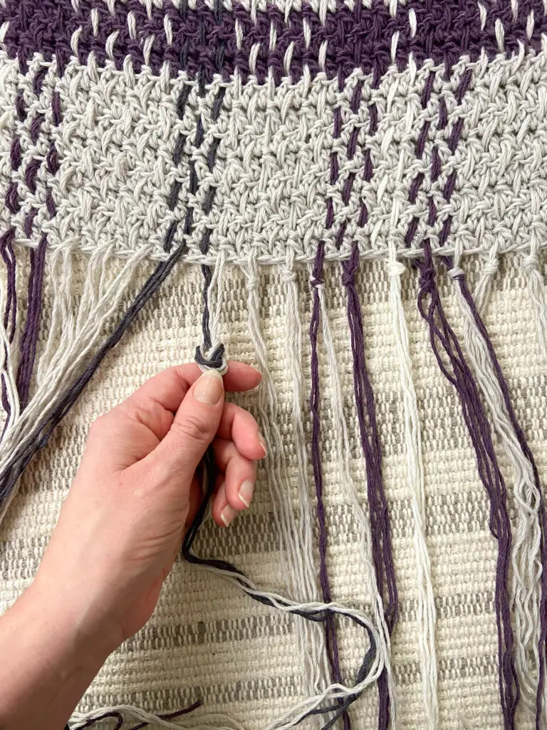 Tie a knot at the base of the fringe.