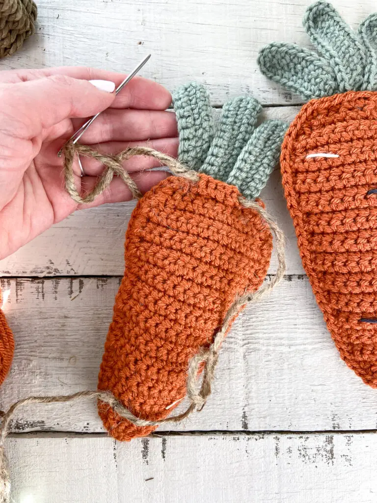 String carrot with twine to make garland.