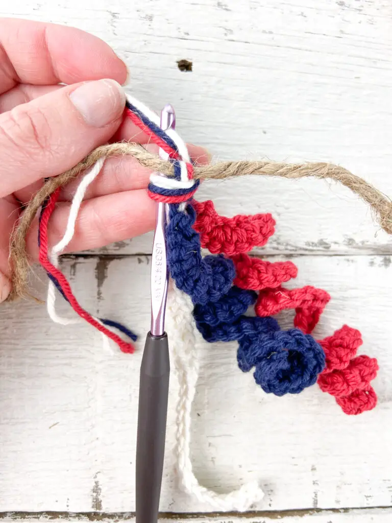 attaching the stripes bundles to the crochet garland
