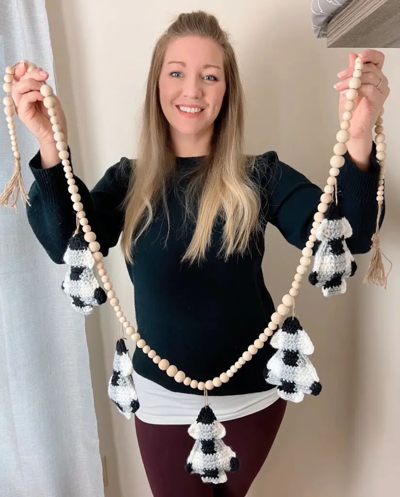 woman holds a crochet buffalo check bunting