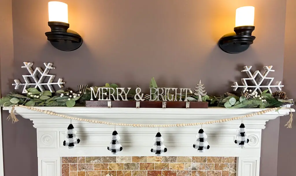 Buffalo plaid christmas crochet garland hung on a mantle